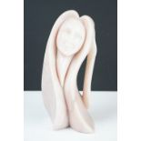 Carved pink stone sculpture of a stylised female, engraved 'Morning Rise' and signed to base, approx