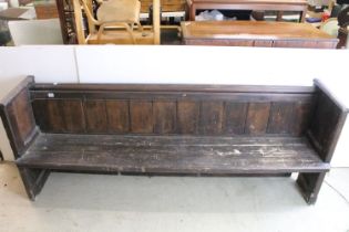 Stained panelled pew, the end carved with arches and quatrefoil design, 81cm high x 207cm wide x