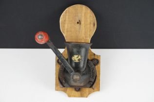 Spong & Co Ltd cast iron spice grinder on a wooden wall mount