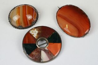 A collection of three scottish agate brooches mounted to white metal