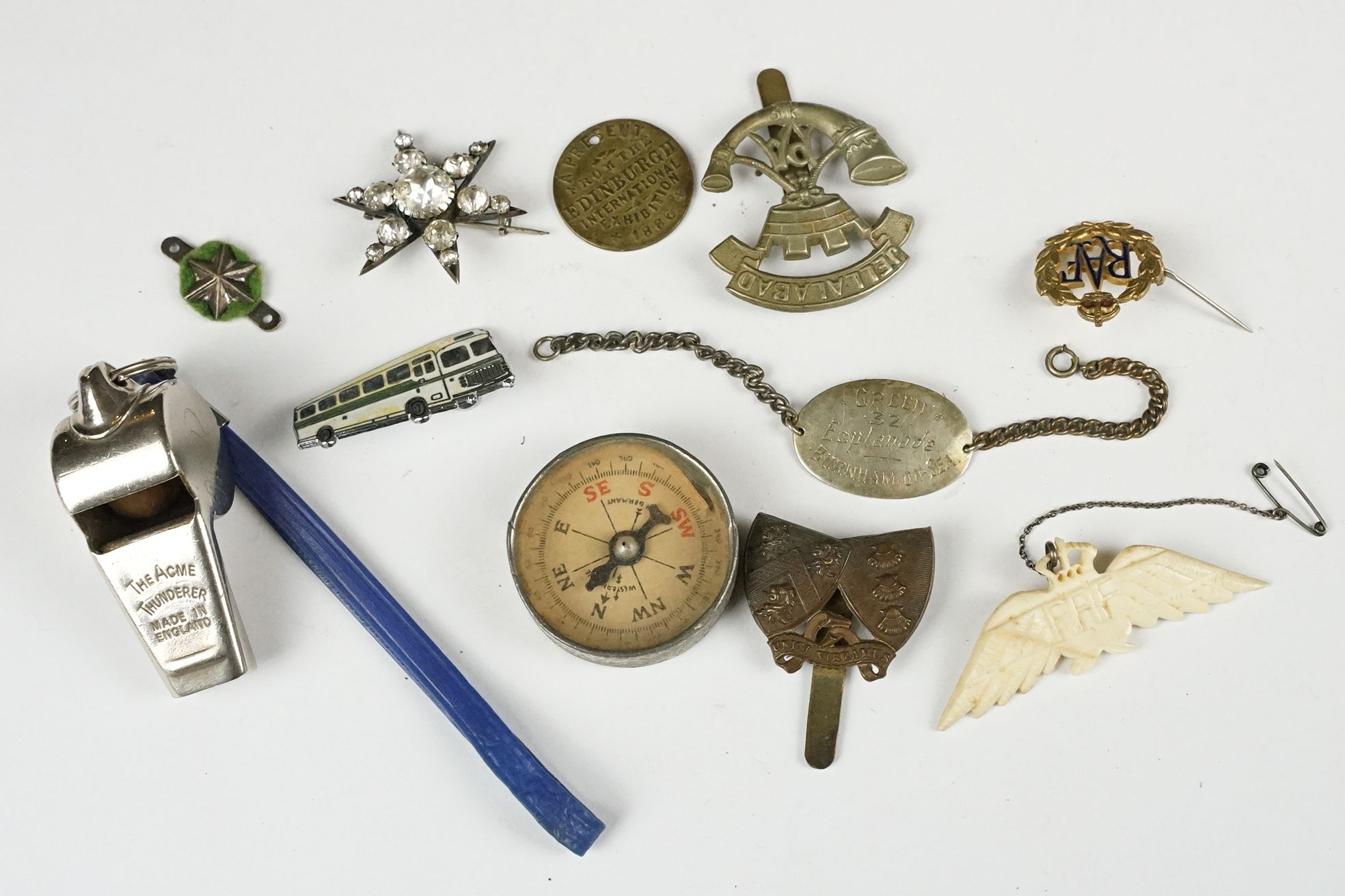 A small group of mixed collectables to include pocket compass, whistle, military badges...etc..