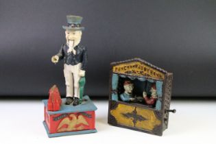 Two reproduction cast iron money boxes to include a Punch and Judy box and an Uncle Sam example.