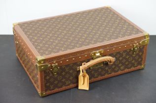 Louis Vuitton - Monogrammed canvas trunk with brass fittings and lock, opening to reveal beige