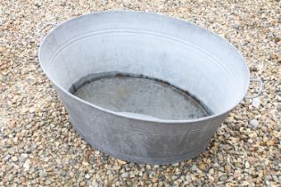 Large galvanised oval garden planter or washtub with twin handles, 96cm long x 36cm high