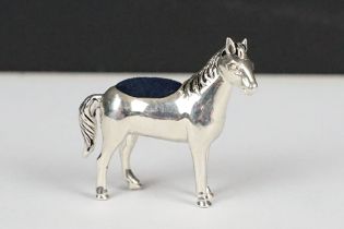 A silver pin cushion in the form of a horse, 4cm high