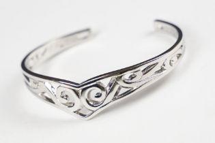 A 925 sterling silver open ended bangle with pierced Celtic style decoration, marked 925 for