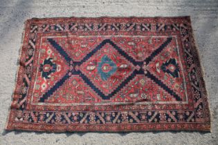 Middle Eastern red ground rug, with central medallion and two half medallions, 197cm x 132cm