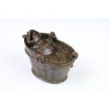 Chinese copper incense burner in the form of a toad bathing in a bathtub, with character marks.