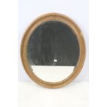 Bevelled glass mirror of oval form with oval painted plaster frame