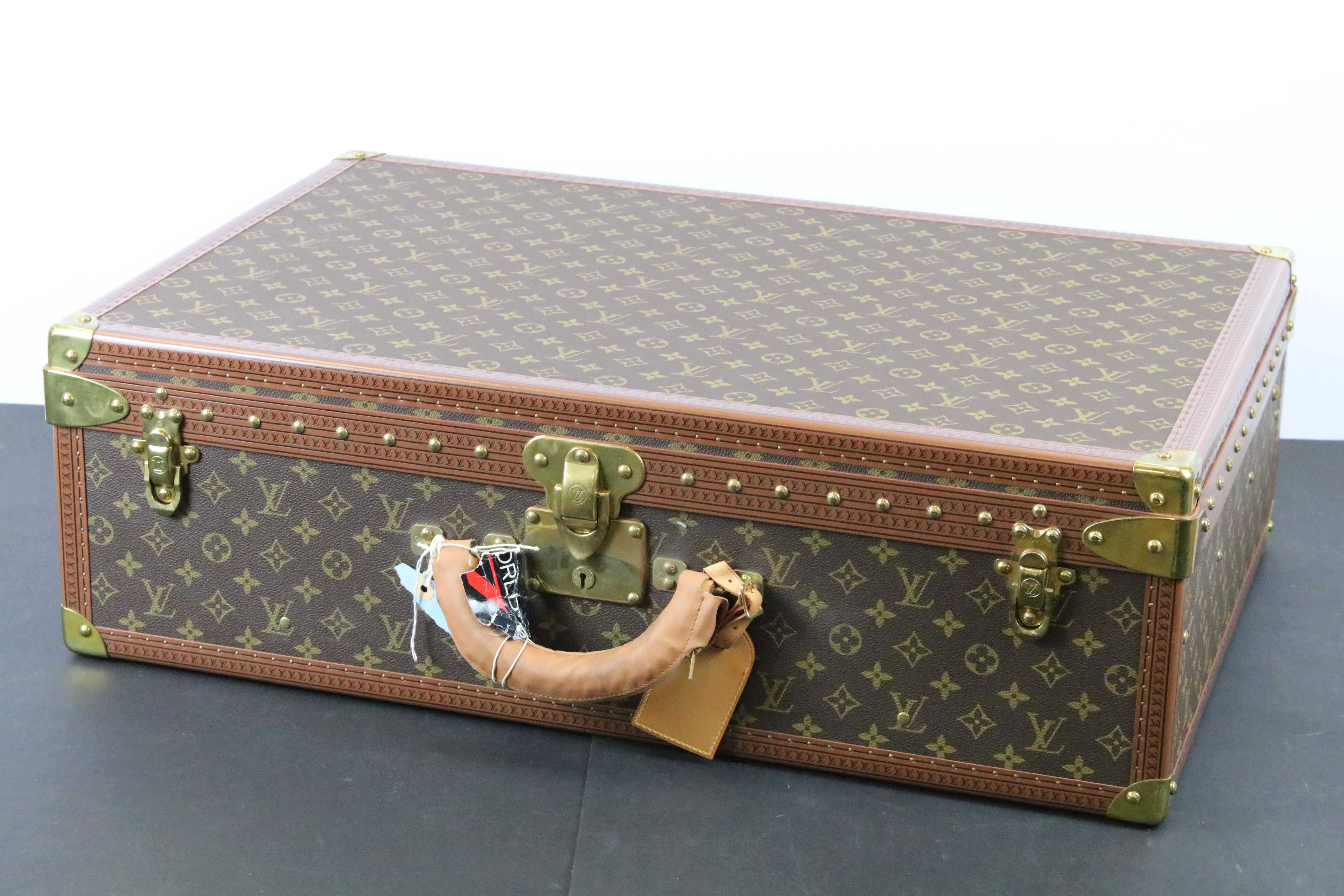 Louis Vuitton - Monogrammed canvas trunk with brass fittings and lock, opening to reveal beige