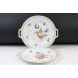 Two Dresden porcelain twin handled plates with hand painted floral decoration and gilt detail to