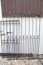 Two wrought iron metal gates, with two gate posts, the larger 170cm high x 115cm wide (including