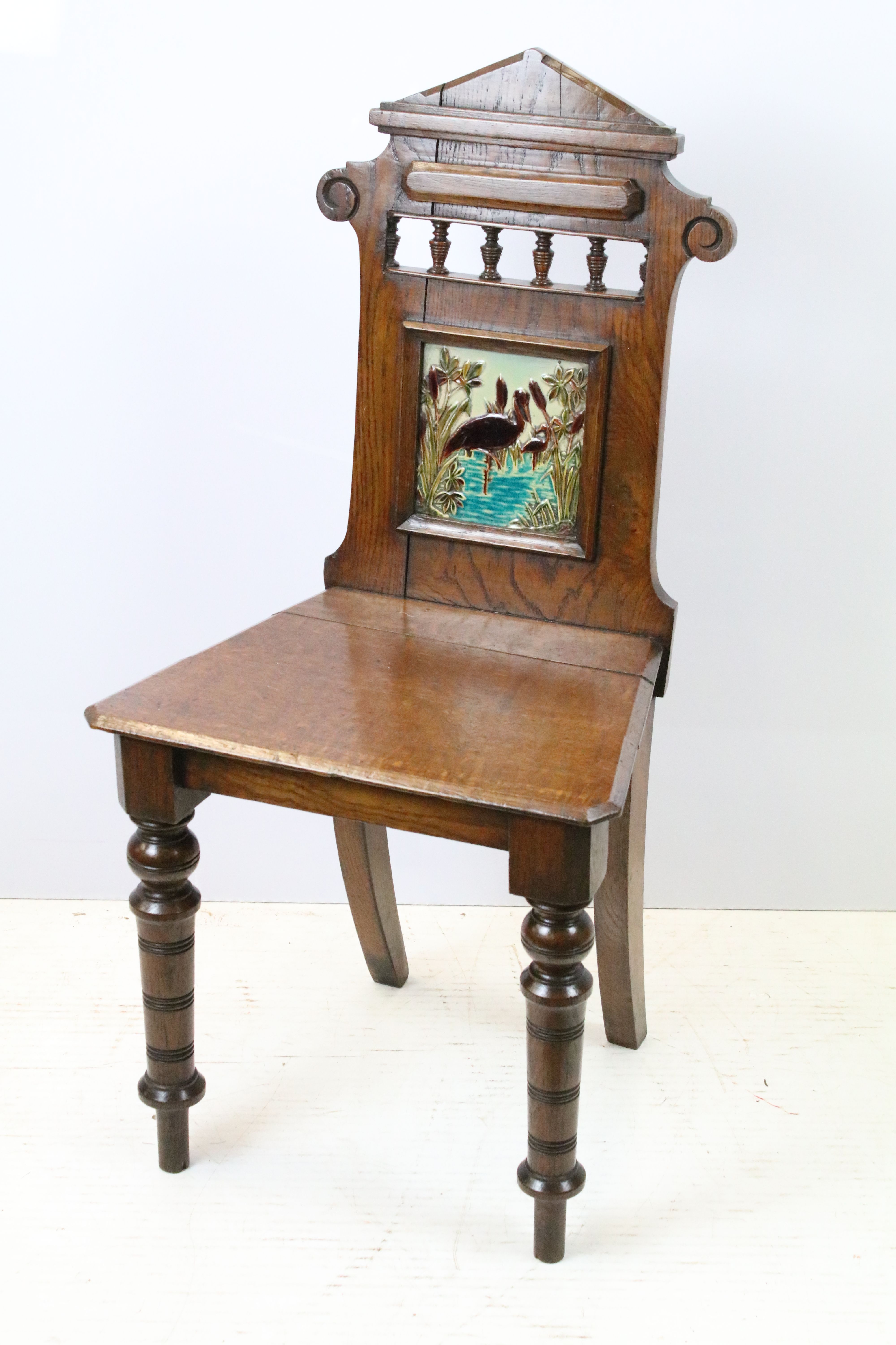 Victorian oak hall chair with Majolica inset tile to back, 90cm high x 44cm wide x 36cm deep