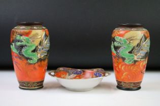 Pair of Japanese Porcelain hand painted Vases decorated in relief with dragons on an orange