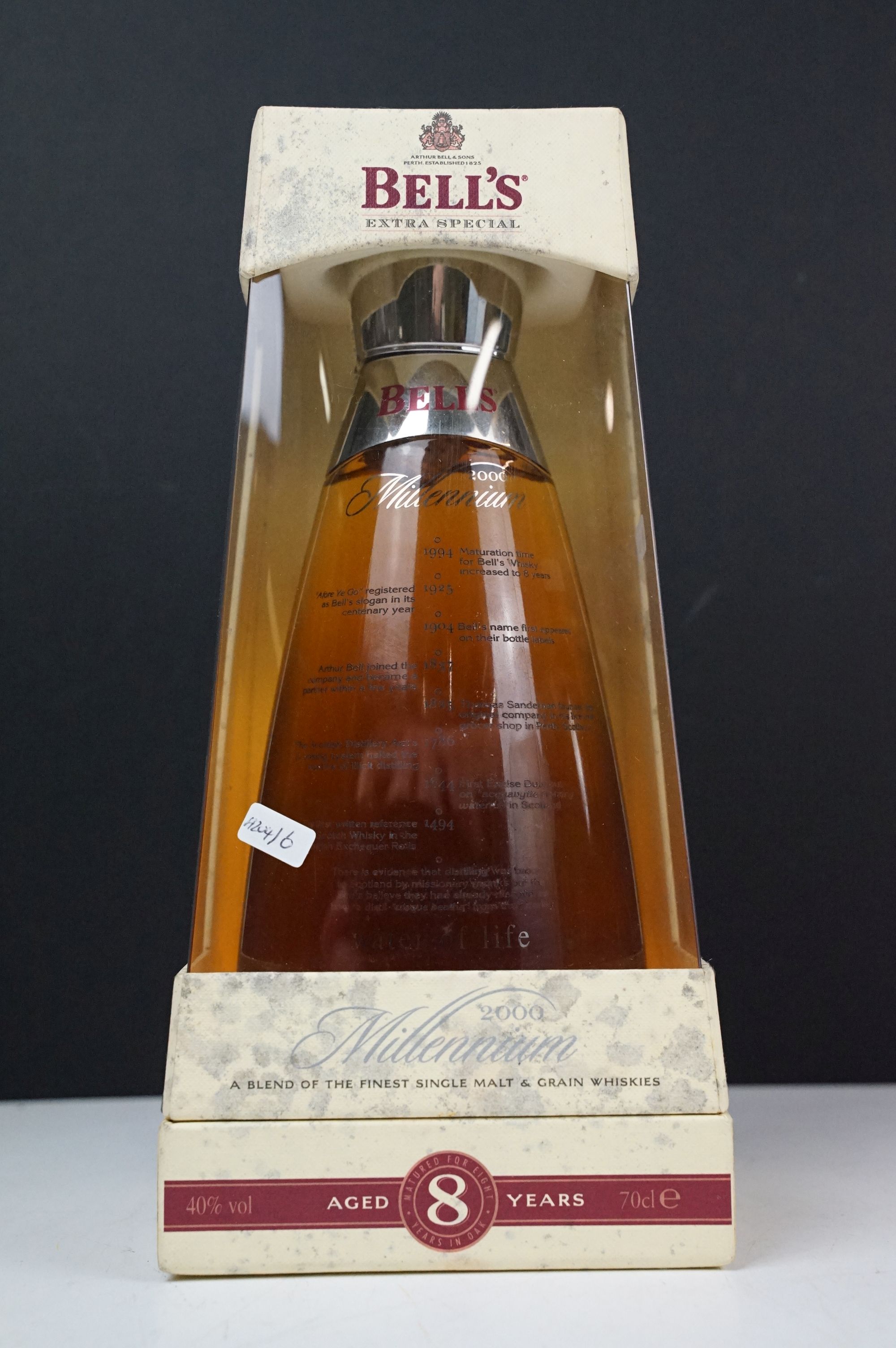 A bottle of Bells 8 year old 2000 millennium whisky in glass decanter presentation box. 70cl, 40%