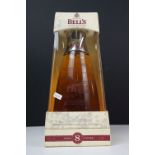 A bottle of Bells 8 year old 2000 millennium whisky in glass decanter presentation box. 70cl, 40%