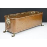 Copper planter of rectangular form with rounded corners and rolled edge, having a pair of lion