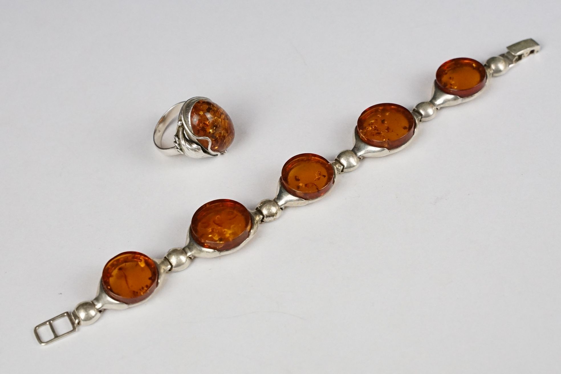 Silver and amber five panel bracelet, marked 925, 19.5cm long (extended) together with an Art