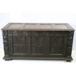 19th century carved oak chest of substantial proportions, the four panelled lid above carved