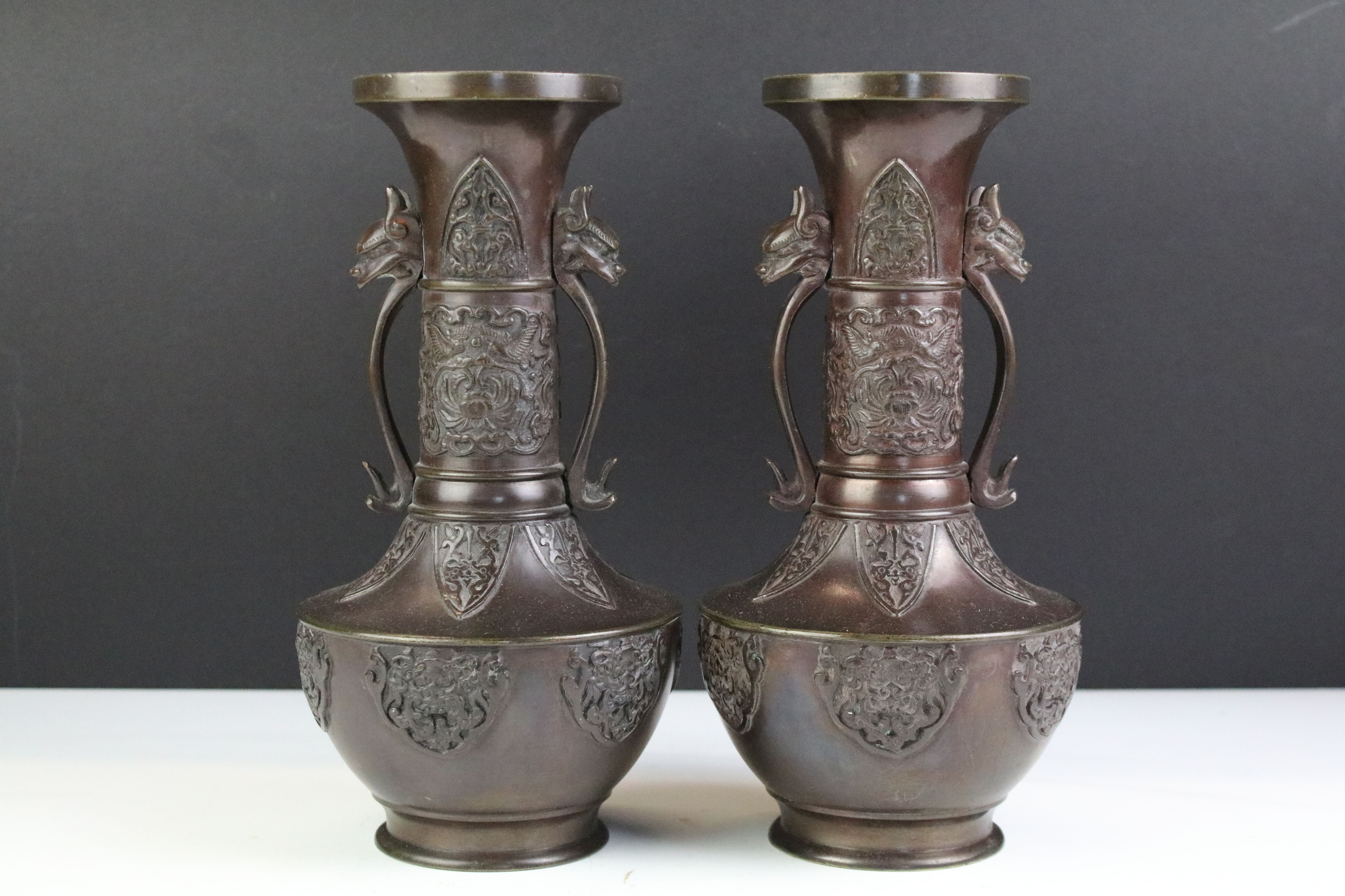 Pair of Chinese Bronze Vases, the twin handles in the form of mythical beast heads, 24cm high