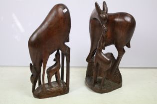 Pair of African carved hardwood figurines in the form of antelope mothers and calves.