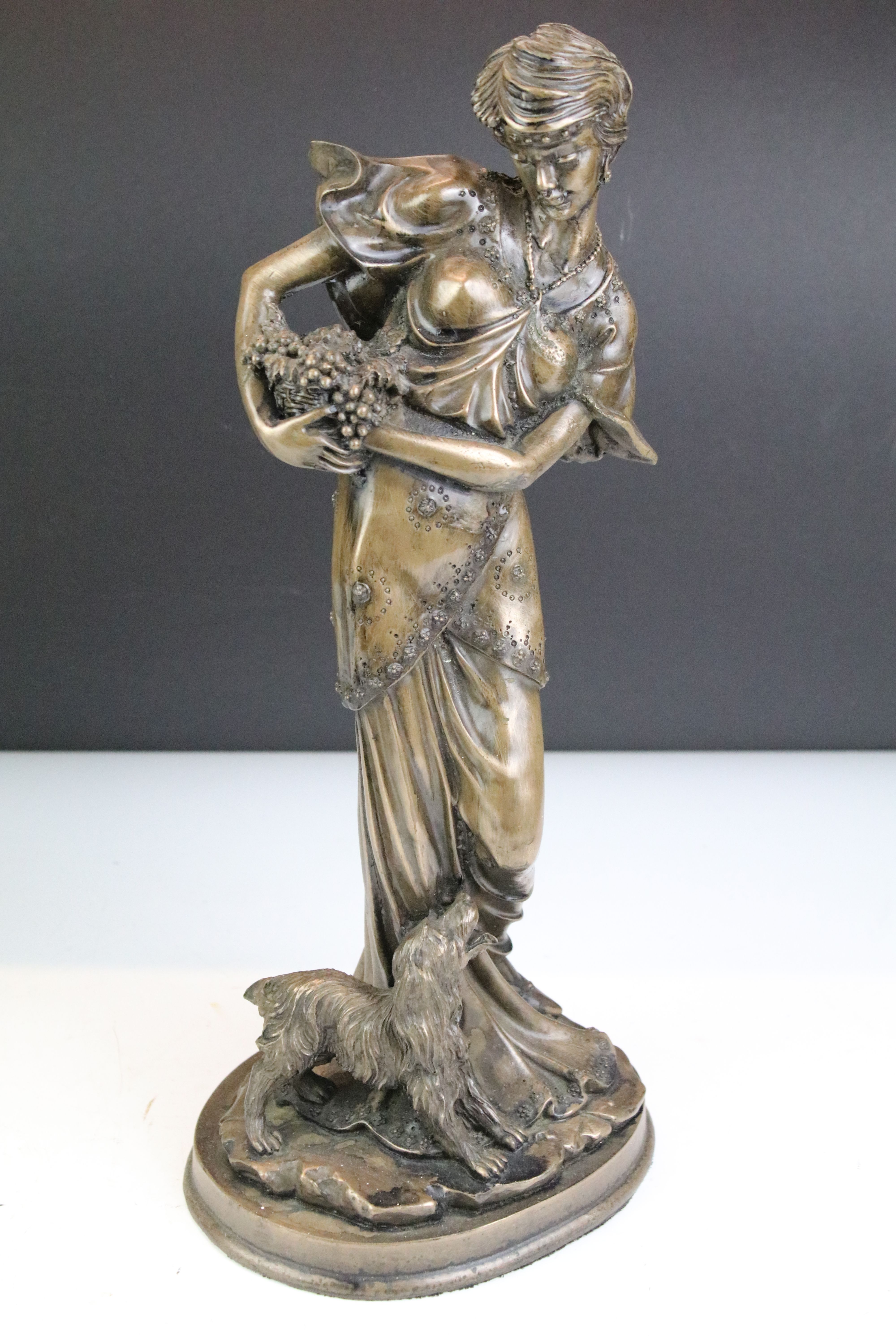 Two 20th Century cast resin faux bronze figurines in the form of a female figure holding a basket of - Image 2 of 8