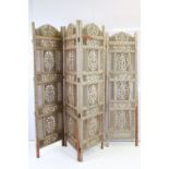 Indian carved wooden folding screen with four sections, all having carved detailing. Measures