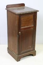 Early 20th Century mahogany side cabinet having a flared top with panelled cupboard with shelf