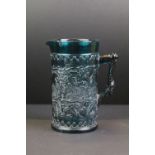 19th century Kingfisher blue pressed glass jug with leaf & berry detail, approx 16cm tall