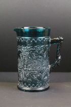 19th century Kingfisher blue pressed glass jug with leaf & berry detail, approx 16cm tall