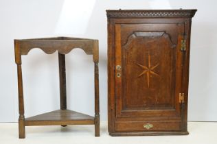 Georgian oak corner cupboard, with dentil cornice above panelled door with parquetry geometric