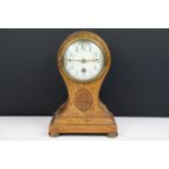 Edwardian balloon oak mantel clock with white enamel dial and carved detail, approx 22.5cm high