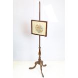 Victorian mahogany fire screen stand having an embroidered framed picture raised on tripod stand.