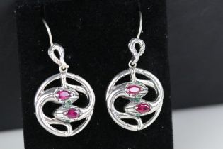Pair of silver and ruby snake style earrings, cased