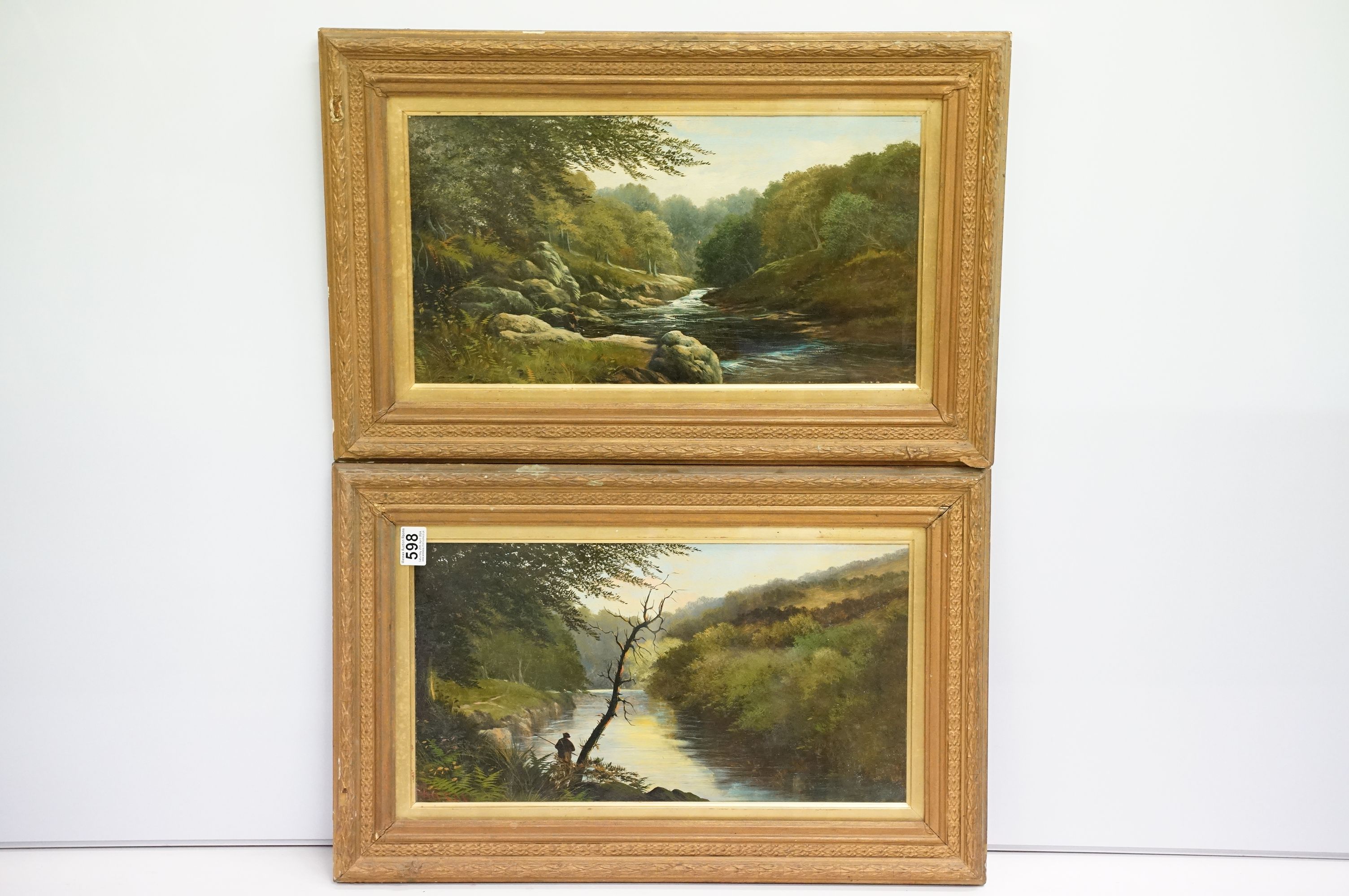 Pair of late 19th / early 20th century oil on board paintings of a fisherman by a lake and river,