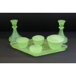 Early-to-mid 20th century frosted uranium glass dressing table set, comprising candlesticks, jars,