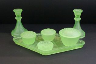 Early-to-mid 20th century frosted uranium glass dressing table set, comprising candlesticks, jars,