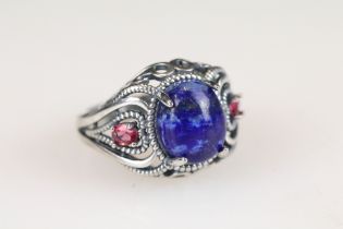 A ladies dress ring set with blue central cabochon, marked 925 to the shank