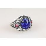 A ladies dress ring set with blue central cabochon, marked 925 to the shank