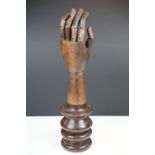 Artist model hand with articulated fingers, raised on a turned wooden base, approx 44cm high