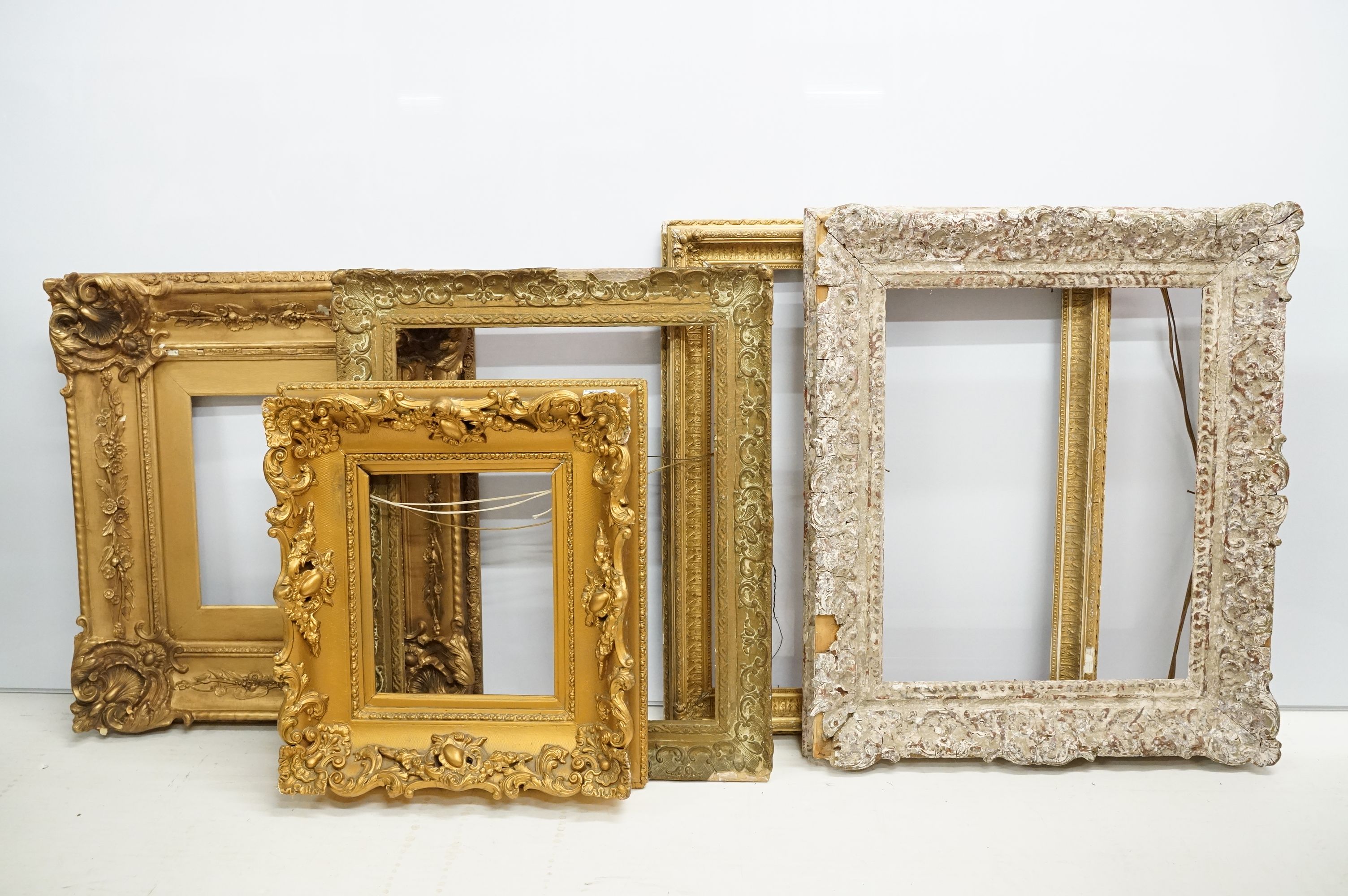 Collection of five picture frames all with moulded details including four gilt. Largest measures