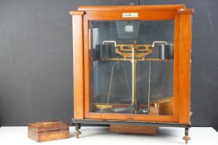 Set of vintage Oerting balance scales set within a glazed wooden case with a set of brass weights