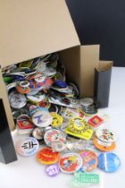 Collection of pin badges of varying subjects, featuring advertising examples