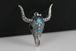 A large steer / bull head pendant set with turquoise cabochons, marked 925 to the verso.