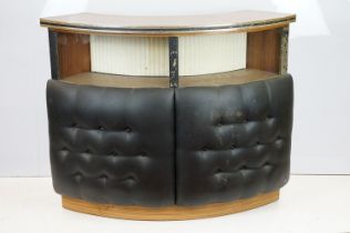 Mid 20th century curved bar with glass windows above the buttoned cushioned front, with sliding