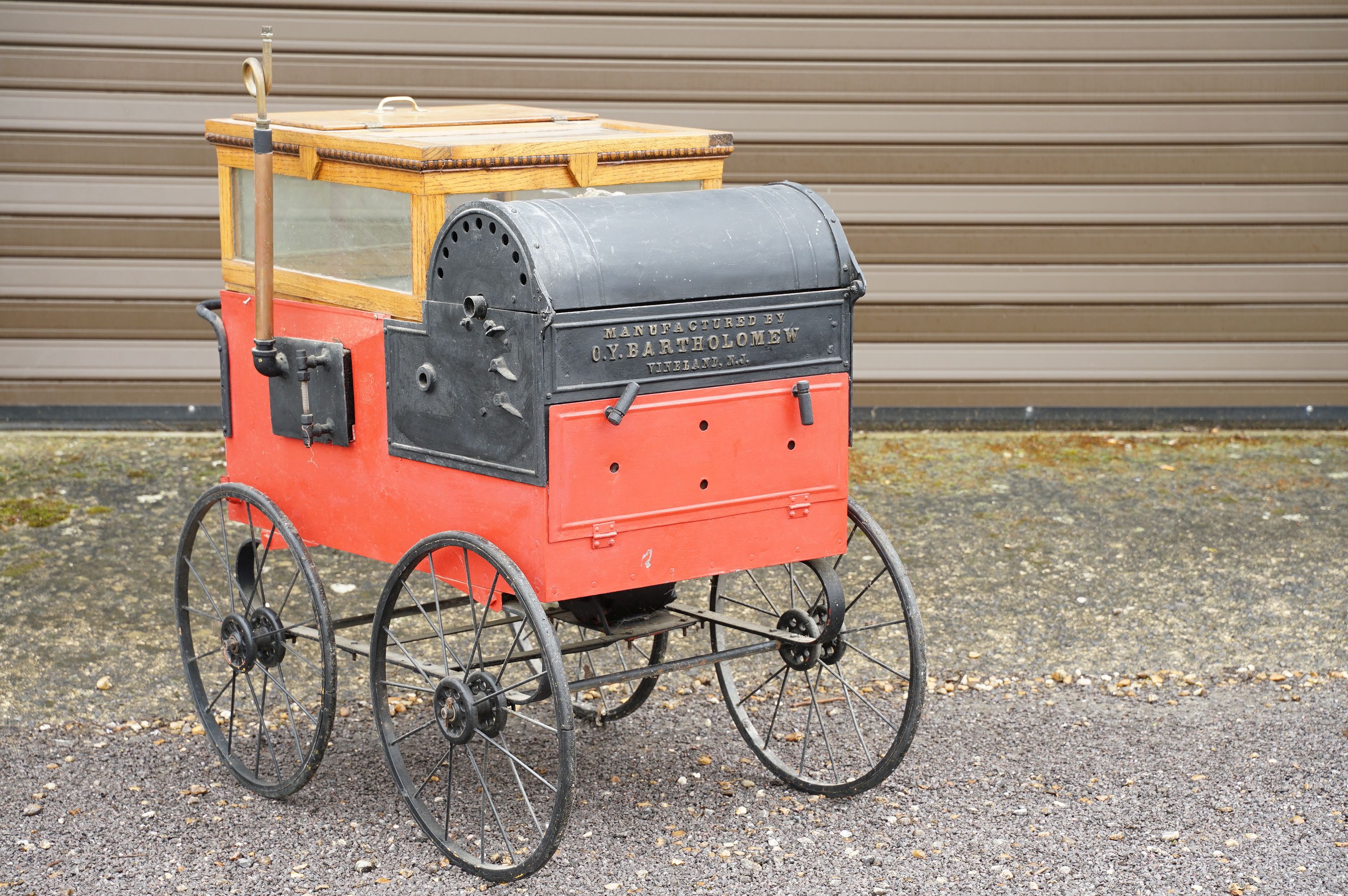 Vintage American chestnut cart raised on four wheels with oak glazed case to top with burner to