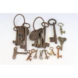 Collection of metal keys, mostly antique examples, featuring keys on a ring with metal plaque /