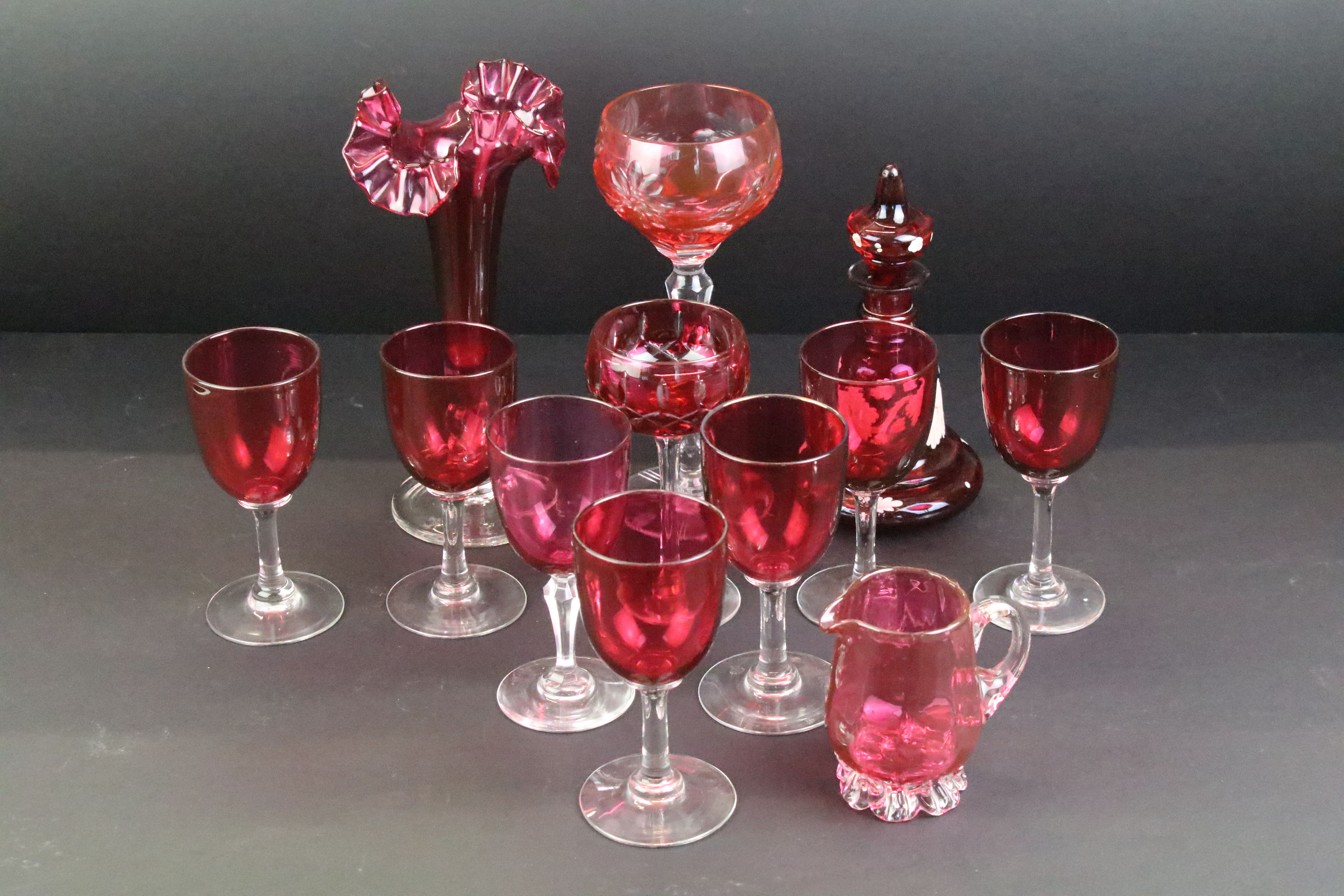 Collection of cranberry glassware, 19th century onwards, to include a set of seven drinking glasses,