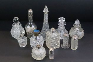Collection of 12 cut glass perfume bottles & jars to include silver collared & silver lidded