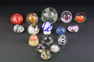 Collection of 20th century paperweights of varying size & colour, featuring floral examples